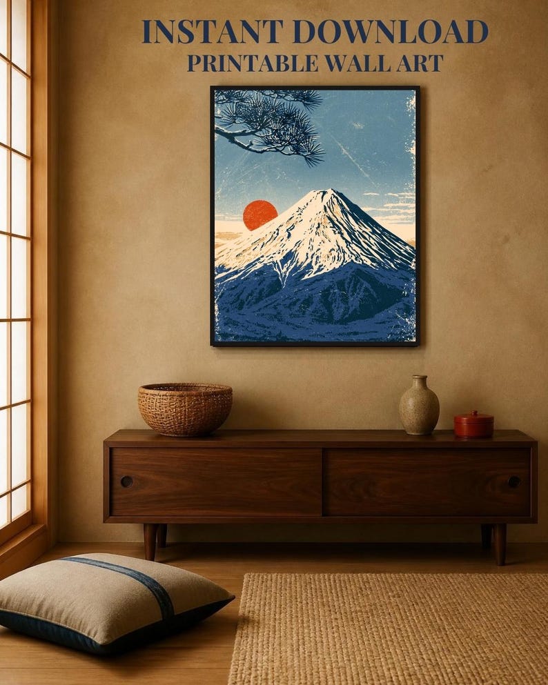 May include: A framed wall art print featuring a stylised illustration of a snow-capped mountain peak under a blue sky with a large red sun and pine branches. The text INSTANT DOWNLOAD PRINTABLE WALL ART is displayed above the framed artwork.