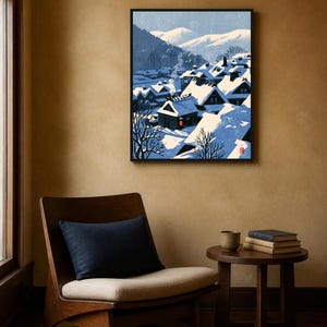 May include: A framed wall art print depicting a snow-covered village nestled in a valley with mountains in the background. The scene features dark-roofed houses with white snow, a single red lantern, and a small red seal in the bottom corner.