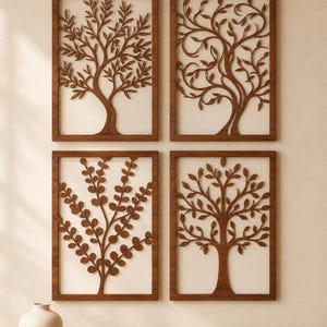 May include: Four rectangular wooden wall panels featuring intricate laser-cut tree designs. Each panel displays a different tree species with detailed branches and leaves, framed in a dark brown wood finish, arranged in a two-by-two grid pattern.