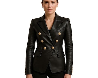 Pode incluir: Um blazer de couro preto com design de abotoamento duplo. O blazer apresenta botões dourados e dois bolsos frontais. As mangas são compridas e o casaco tem um corte sob medida.