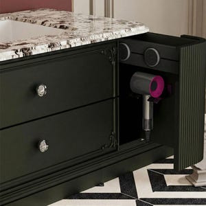 May include: A white ceramic mug with a black handle and the text "But First, Coffee" in a black, handwritten-style font. The mug is on a white surface.