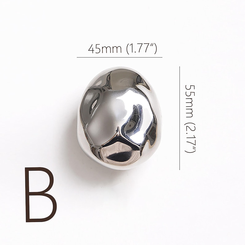 May include: A white ceramic mug with a black handle and the text "But First, Coffee" in a black, handwritten-style font. The mug is on a white surface.