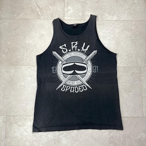 May include: Black tank top with a graphic design. The design includes the text "S.R.H. Run Tue Underground Spuded 1991" in a circular pattern with crossed swords and a stylized face. The tank top has a faded, vintage look.