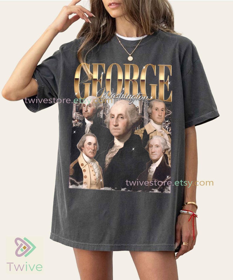 May include: Dark gray t-shirt featuring a portrait of George Washington and the text "GEORGE Washington" in gold lettering. The shirt has a vintage, distressed look, with the Etsy shop name "twivestore.etsy.com" printed on it.