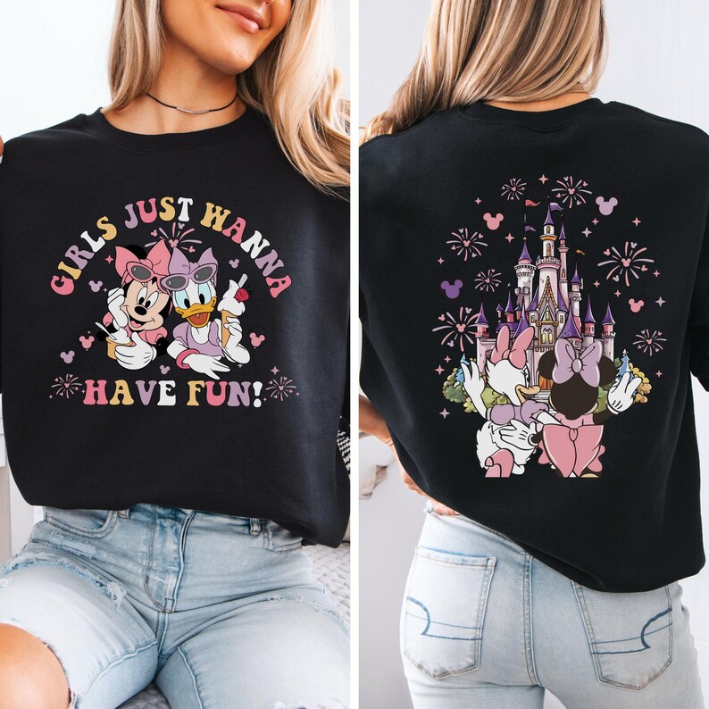 May include: Black sweatshirt with a graphic of Minnie Mouse and Daisy Duck, and the text "GIRLS JUST WANNA HAVE FUN!" on the front. The back shows a castle, fireworks, and Minnie and Daisy.