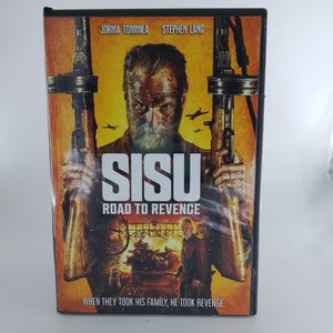 May include: DVD case for the movie "SISU: Road to Revenge." The cover features Jorma Tommila and Stephen Lang. The image shows a man holding two machine guns against a yellow and orange background. The text "SISU" is prominently displayed.