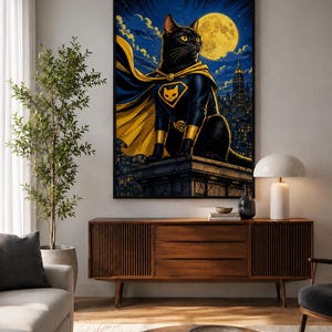 May include: A framed wall art print featuring a black cat dressed as a superhero with a yellow cape and emblem, perched on a building ledge against a dark blue night sky with a large yellow full moon and a distant city skyline silhouette.