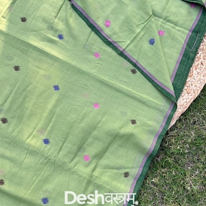 May include: Pale green fabric with small, colourful floral patterns. The fabric has a dark green border with a thin purple stripe. The text "Fab088" is visible in the upper right corner, and "Desh वस्त्रम" is in the lower left.