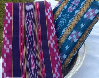 May include: Two patterned fabric pieces in a woven basket. One is dark purple with pink and gold stripes, the other is teal with purple and gold accents. The text "Desh" and "fab040" are visible.