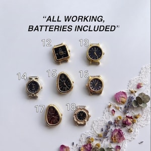 May include: Seven gold-tone watch faces with black dials, labeled 12 through 18. The text ALL WORKING, BATTERIES INCLUDED is at the top. The watch cases vary in shape, including square, round, teardrop, and floral designs, all featuring analog displays.