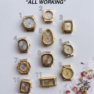 May include: Eleven gold-tone watch heads labeled with numbers one through eleven, arranged on a white surface with the text ALL WORKING at the top. The collection includes various shapes such as round, square, oval, and teardrop, all featuring analog dials.