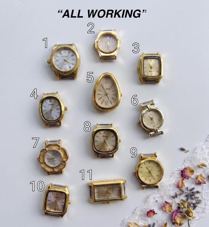 May include: Eleven gold-tone watch heads labeled with numbers one through eleven, arranged on a white surface with the text ALL WORKING at the top. The collection includes various shapes such as round, square, oval, and teardrop, all featuring analog dials.