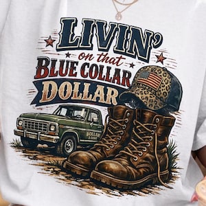 May include: White t-shirt with the text "Livin' on that Blue Collar Dollar" in blue, red, and white. The graphic includes a green pickup truck, brown work boots, and a trucker hat with an American flag design.