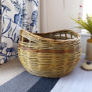 A handmade barrel shaped willow basket with gap handles