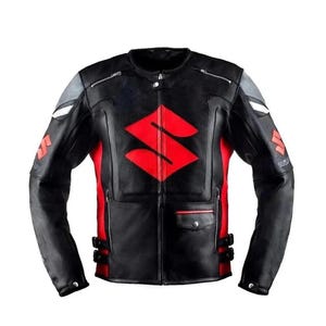 May include: Black and red leather motorcycle jacket with the Suzuki logo prominently displayed on the chest. The jacket features a zippered front, pockets, and gray accents on the shoulders. A stylish piece of outerwear.