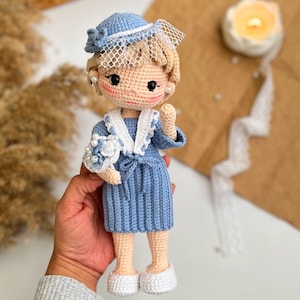 May include: A white ceramic mug with a black handle and the text "But First, Coffee" in a bold, black font. The mug is sitting on a wooden surface. The mug is approximately 4 inches tall.