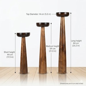 May include: Three wooden pedestal stands with varying heights. The tallest is 64 cm (25.2 in) high, the medium is 54 cm (21.3 in), and the shortest is 44 cm (17.3 in). Each stand has a dark, round top with a diameter of 14 cm (5.5 in).