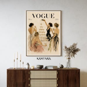 May include: A framed wall art print featuring a vintage Vogue magazine cover illustration. The artwork depicts four figures in evening gowns gathered around a tall champagne tower. The text VOGUE, PARIS, AVRIL 1950, and BEAUTE CULTURE are visible.
