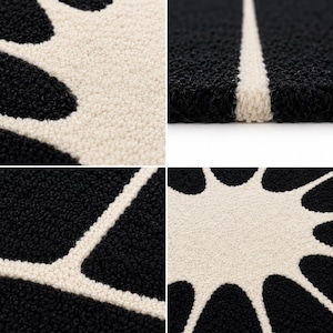 May include: A tufted rug featuring a high-contrast black and cream color scheme. The design consists of a central cream-colored sunburst or floral pattern with radiating petals set against a deep black background, showcasing a thick, textured pile.