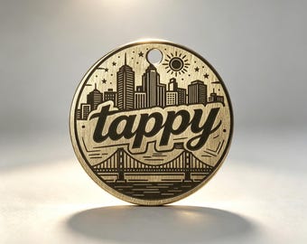 Personalized brass pet ID tag featuring an etched vintage city skyline design and a hanging hole.
