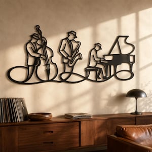 May include: A black metal wall art piece featuring a continuous line design of a jazz trio. The silhouette depicts three musicians wearing hats, playing a double bass, a saxophone, and a grand piano, connected by a flowing, curved line base.