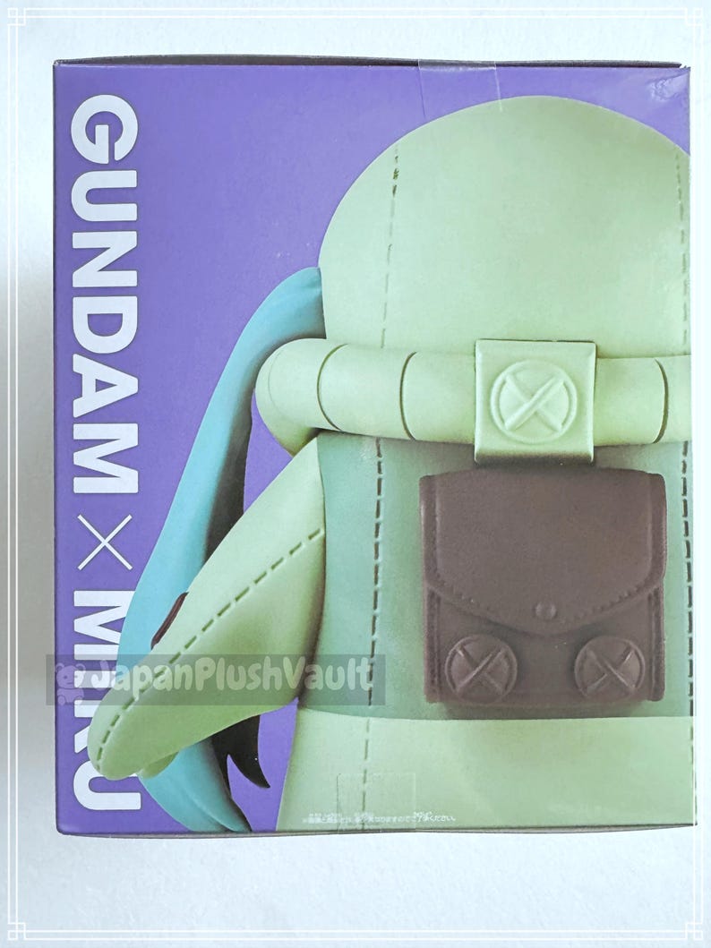 May include: A plush toy figure in a box. The figure is light green with a brown pouch and blue accents. The box has the text "GUNDAM x MIKU" in white on a purple background.