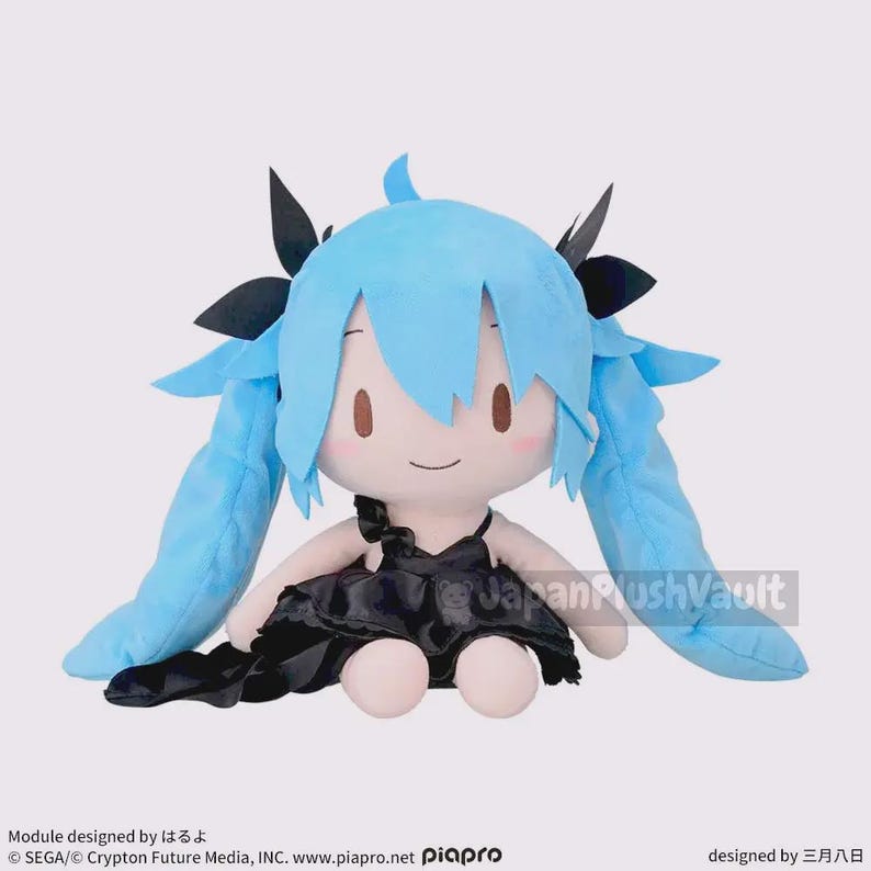 May include: A plush doll featuring a character with light blue hair and a black dress. The doll has a smiling face with brown eyes and is sitting down. The doll's hair is styled in pigtails. The doll is a collectible item.