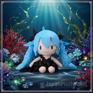 May include: A plush doll with light blue hair and a black dress, set against an underwater scene with coral and gems. The doll has a smiling face and long pigtails. The background features various shades of blue and green.