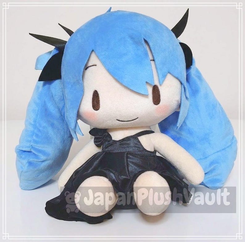 May include: A plush doll with a light blue wig and long pigtails. The doll has a white face with brown eyes and rosy cheeks. It is wearing a black dress with a bow and black hair accessories. The doll is sitting.