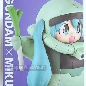May include: A collectible figure of a character in a light green suit with blue hair, holding a green and white vegetable. The figure is in a box with the text "GUNDAM x MIKU" on a purple background.