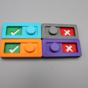 May include: Four colorful plastic toggles with a checkmark or an X on one side and a round button on the other. The toggles are blue, orange, gray, and purple.