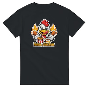 May include: Black t-shirt featuring a cartoon chicken with a red comb and yellow beak, holding fried chicken drumsticks. The chicken is surrounded by flames and the text "hmm, chicken" is below the image.