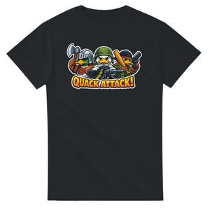 May include: Black t-shirt featuring a cartoon graphic of three ducks armed with weapons and wearing helmets. The ducks are holding an axe, a machine gun, a baseball bat, and a pistol. The text "QUACK ATTACK!" is in a yellow and orange bubble.