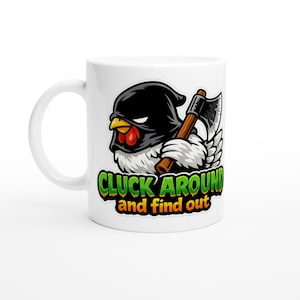 May include: White ceramic mug with a cartoon chicken in a black executioner's hood, holding an axe. The mug displays the text "CLUCK AROUND and find out" in green and orange lettering.