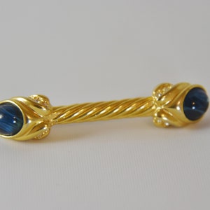Gold Tone Bar Brooch with Crystals and Blue End Cabochons. Double Stone Bar Brooch with Blue stones and Clear Rhinestones.