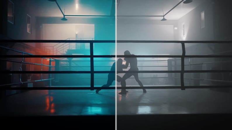 May include: A boxing ring with two figures engaged in a fight. The ring is surrounded by black ropes and posts. The scene is illuminated with blue and orange lighting, creating a dramatic atmosphere.
