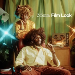 May include: A photograph with a retro aesthetic, featuring two people in a room with plants and a vintage reel-to-reel tape recorder. The text "35mm Film Look" is visible. The people are wearing yellow shirts and brown trousers. The lighting creates a warm, nostalgic atmosphere.