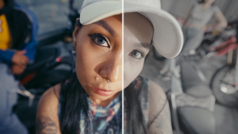 May include: A split-screen portrait of a person wearing a white baseball cap, with one side in colour and the other in grayscale. The person has dark hair, a nose ring, and visible tattoos.