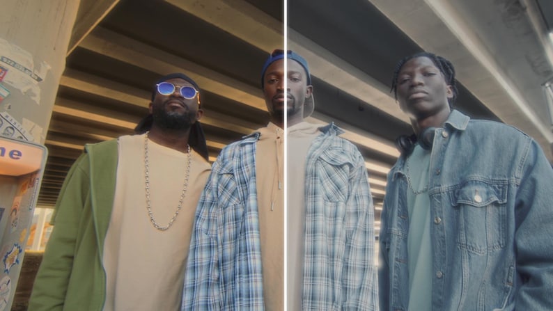 May include: Three people stand under a concrete structure. The person on the left wears sunglasses, a tan shirt, and a green jacket. The middle person wears a blue plaid shirt. The person on the right wears a denim jacket.