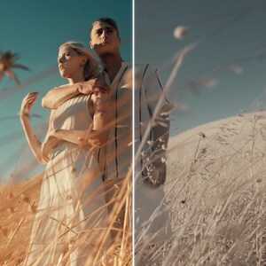 Puede incluir: Una pareja se encuentra en un campo de hierba alta y seca bajo un cielo azul claro. La mujer lleva un vestido blanco y el hombre la abraza. La escena est&aacute; ba&ntilde;ada por la c&aacute;lida luz del sol, creando una atm&oacute;sfera rom&aacute;ntica y serena.