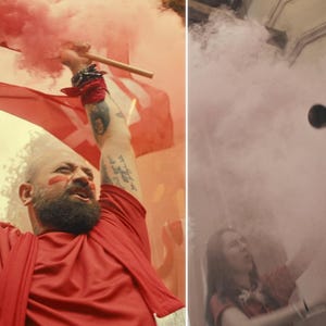 May include: A man in a red shirt holds a red flag and a smoke flare, surrounded by pink smoke. The image captures a moment of celebration or protest, with a focus on the vibrant colors and dynamic action.