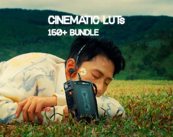 May include: A person lying in grass with a vintage cassette player and earbuds. The person wears a cream-colored sweater with a colorful pattern. Text at the top reads "CINEMATIC LUTS 150+ BUNDLE". The background features a green hillside.