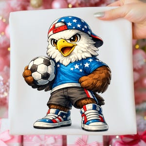 May include: A cartoon illustration of an eagle wearing a blue shirt with white stars, a baseball cap with stars, and shorts. The eagle is holding a soccer ball and wearing red, white, and blue sneakers. The eagle has brown feathers and a yellow beak.