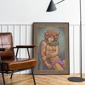 May include: A framed art print featuring a Capricorn zodiac illustration. The artwork depicts a nude figure with horns, curly hair, and a green cape. The print has a decorative border and the word "CAPRICORN" at the bottom.