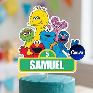 May include: A cake topper featuring Sesame Street characters, including Big Bird, Elmo, Cookie Monster, and others. The topper has a green and white sign that reads "SAMUEL" and the number "5". The cake is teal.