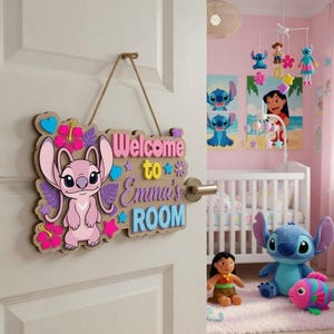 May include: A wooden hanging door sign featuring a pink alien character, tropical flowers, and the text "Welcome to Emma's ROOM" in pink, yellow, and blue. The sign is suspended by a brown twine rope and decorated with various colourful star and heart shapes.