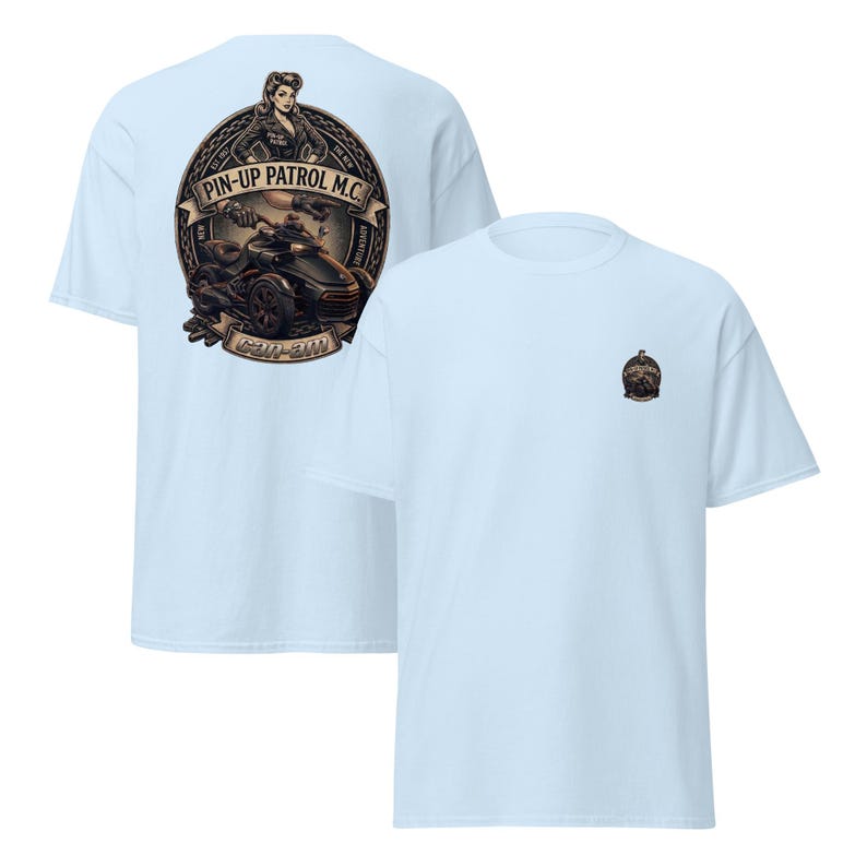Puede incluir: Camisetas de color azul claro con un dise&ntilde;o gr&aacute;fico. Una camiseta presenta un gran emblema con una pin-up, el texto "PIN-UP PATROL M.C." y un veh&iacute;culo Can-Am. La otra camiseta tiene un emblema m&aacute;s peque&ntilde;o.