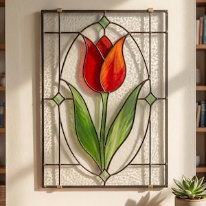 May include: A rectangular stained glass panel featuring a central red and orange tulip flower with green leaves. The design is enclosed in a dark metal frame with a clear, textured glass background and small green glass accents at the intersections.