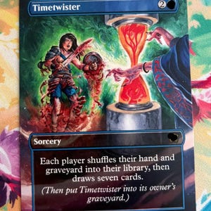 May include: A rectangular trading card titled Timetwister featuring a fantasy illustration of a figure near a glowing red hourglass. The card text reads: Each player shuffles their hand and graveyard into their library, then draws seven cards.