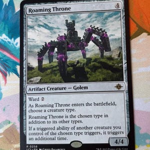 May include: A Magic: The Gathering card titled "Roaming Throne." The card features a black and purple golem-like creature on a grassy hill under a cloudy sky. The card text includes "Artifact Creature - Golem" and "Ward 2."
